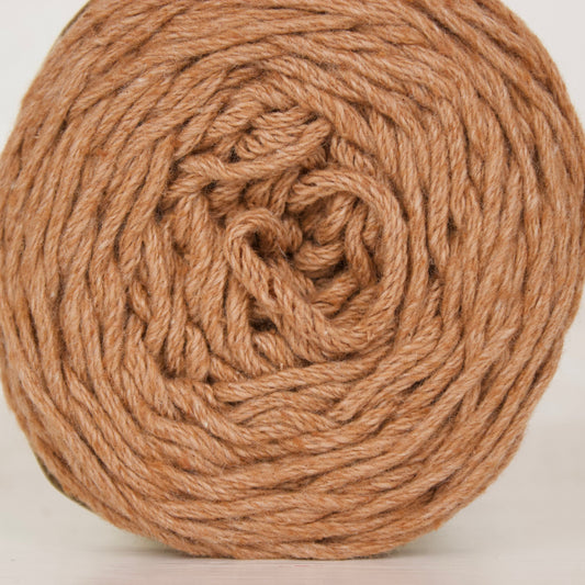 A ball of natural brown cotton yarn wound in a spiral pattern, shown against a plain white background.