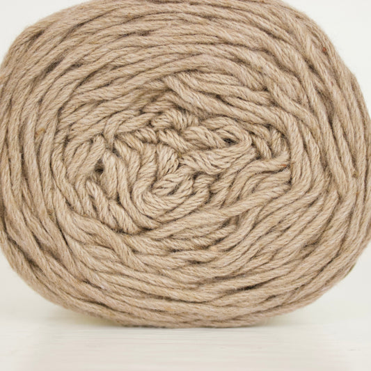 A ball of natural beige cotton yarn wound in a spiral pattern, photographed on a clean white background.