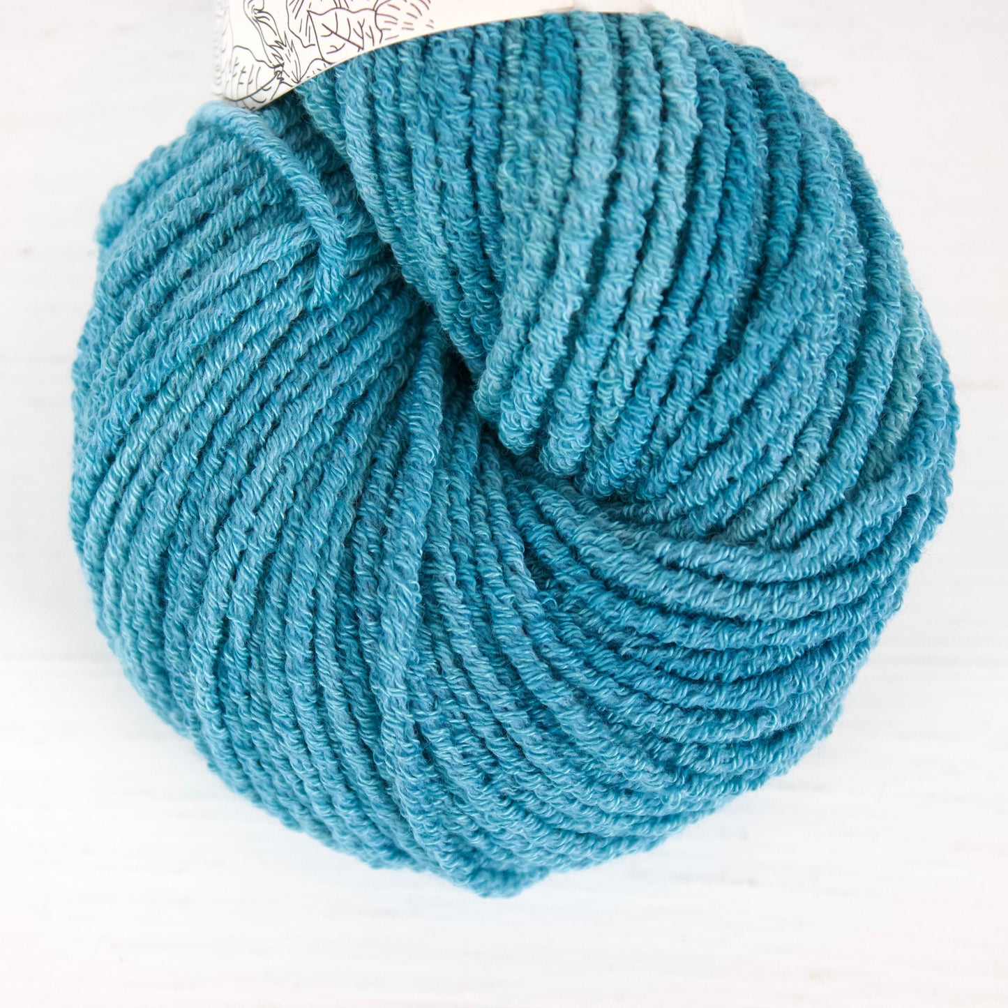 Blue skein of yarn on a white background