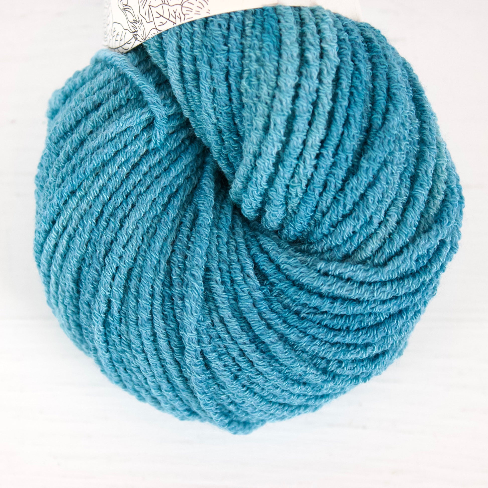 Blue skein of yarn on a white background
