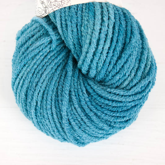Blue skein of yarn on a white background