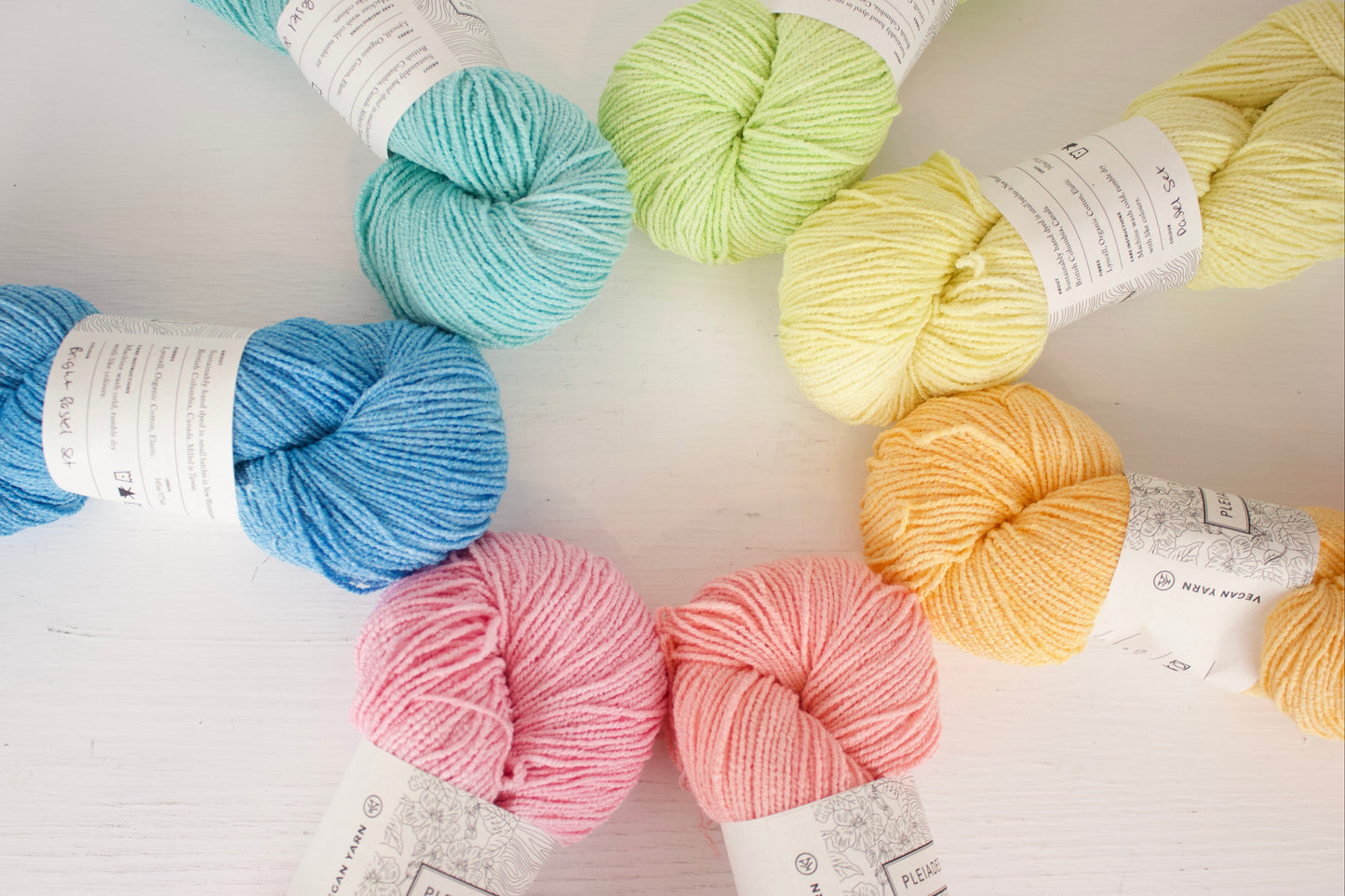 Assorted colorful yarn skeins on a light background