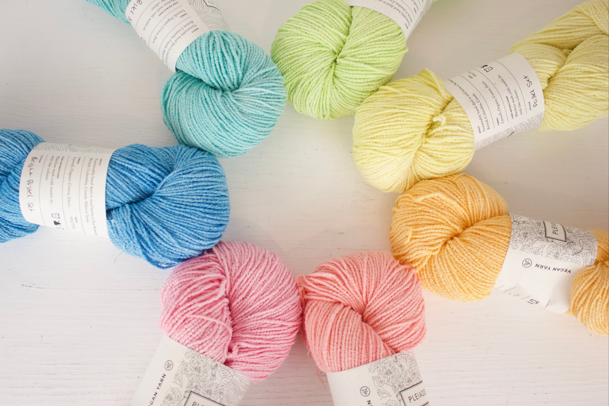 Assorted colorful yarn skeins on a light background