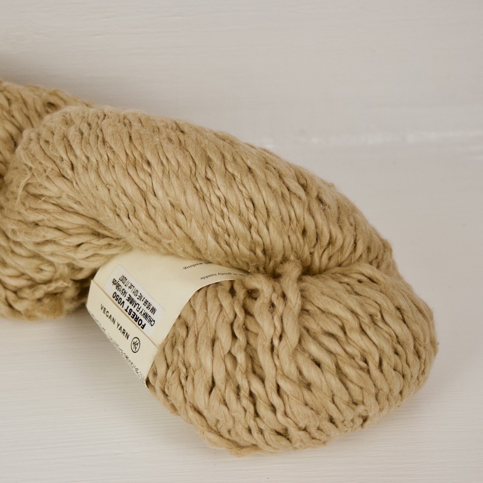 Forest Mist Vega x Pakucho is a thick and thin super bulky that's a natural warm light brownish green that's slightly more yellowy green than avocado pakucho. The skein is large and fluffy.