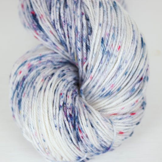 White base yarn with bright indigo and magenta speckles