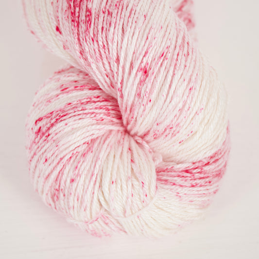 Rasberry oat mylk colourway on albireo fingering yarn base, shown close up