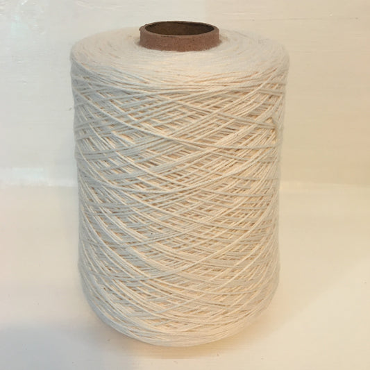 Cone of undyed, ecru coloured yarn on a cardboard cone on a white background. This is the same yarn as Albireo.