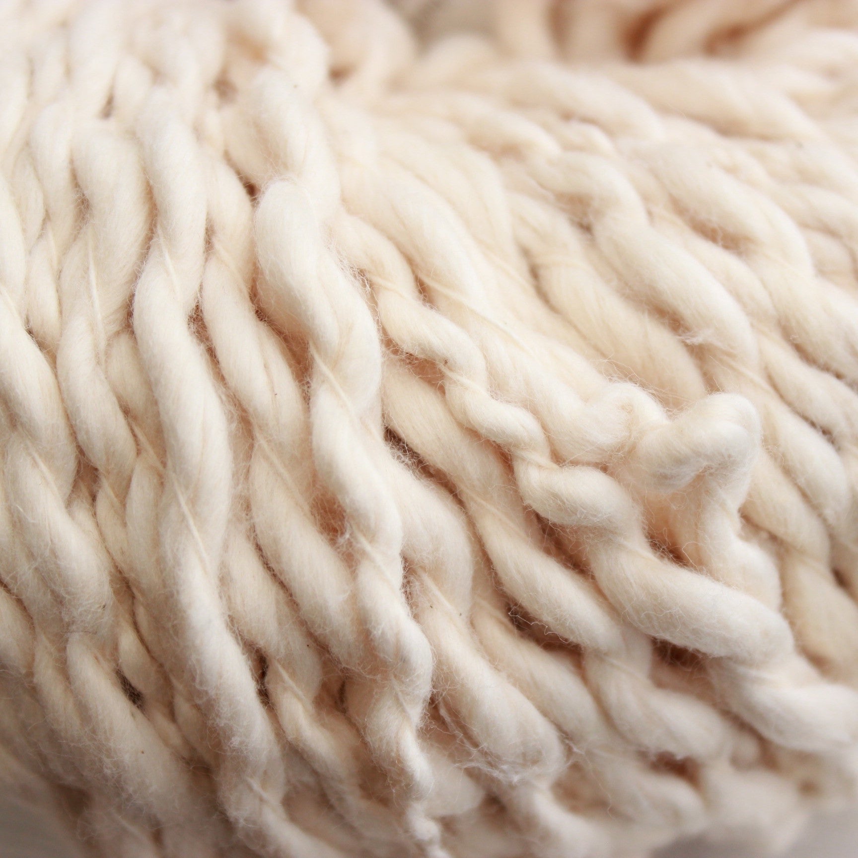 Natural Vega x Pakucho is a thick and thin super bulky that's a natural creamy white. The skein is large and fluffy.